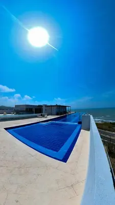 a blue swimming pool on the roof of a building at AZ Apartments in Cartagena de Indias