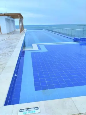 a large swimming pool with blue tiles on it at AZ Apartments in Cartagena de Indias