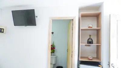 a door to a room with a television on a wall at Hotel Playa Divina in Coveñas