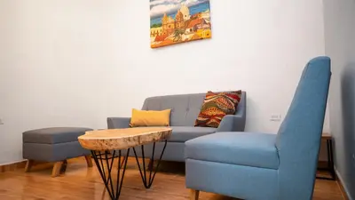 a living room with a couch and a table and chairs at Casa Quero 915 4BR House Old City rooftop jacuzzi AC full Wifi in Cartagena de Indias