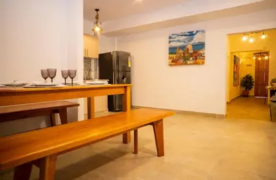 a kitchen with a wooden bench and a refrigerator at Casa Quero 915 4BR House Old City rooftop jacuzzi AC full Wifi in Cartagena de Indias