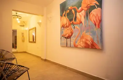 a painting of flamingos on a wall in a hallway at Casa Quero 915 4BR House Old City rooftop jacuzzi AC full Wifi in Cartagena de Indias