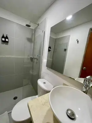 a bathroom with a toilet and a sink and a shower at Casa Quero 915 4BR House Old City rooftop jacuzzi AC full Wifi in Cartagena de Indias