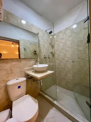 a bathroom with a toilet and a sink and a shower at Casa Quero 915 4BR House Old City rooftop jacuzzi AC full Wifi in Cartagena de Indias