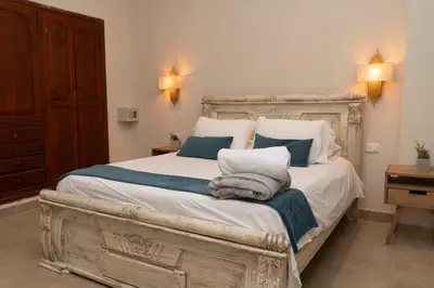 a bedroom with a large bed with towels on it at Casa Badillo 2 OLD CITY CRAZY LOCATION 4br jacuzzi wifi Ac hottub in Cartagena de Indias