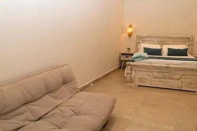 a living room with a bed and a couch at Casa Badillo 2 OLD CITY CRAZY LOCATION 4br jacuzzi wifi Ac hottub in Cartagena de Indias