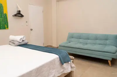 a living room with a couch and a blue sofa at Casa Badillo 2 OLD CITY CRAZY LOCATION 4br jacuzzi wifi Ac hottub in Cartagena de Indias