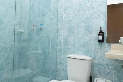 a bathroom with a toilet and a glass shower at Casa Badillo 2 OLD CITY CRAZY LOCATION 4br jacuzzi wifi Ac hottub in Cartagena de Indias