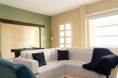 a living room with a white couch and a pool table at Casa Badillo 2 OLD CITY CRAZY LOCATION 4br jacuzzi wifi Ac hottub in Cartagena de Indias
