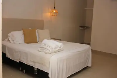 a bedroom with a bed with towels on it at Casa Moneda 1 5BR amazing house picusi AC old city in Cartagena de Indias
