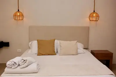 a bedroom with a bed with two towels on it at Casa Moneda 1 5BR amazing house picusi AC old city in Cartagena de Indias