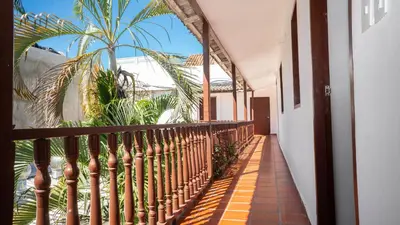 a balcony with a wooden fence and palm trees at Casa Quero 954 COZY HOUSE ROOFTOP POOL AC OLD CITY in Cartagena de Indias