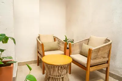 two chairs and a table in a room at Casa Quero 914, 3br Old city wifi jacuzzi in Cartagena de Indias