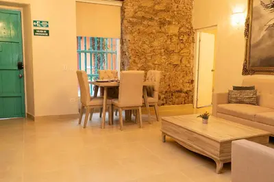 a living room with a table and chairs and a couch at Casa Quero 914, 3br Old city wifi jacuzzi in Cartagena de Indias