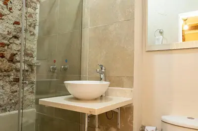 a bathroom with a bowl sink and a shower at Casa Quero 914, 3br Old city wifi jacuzzi in Cartagena de Indias