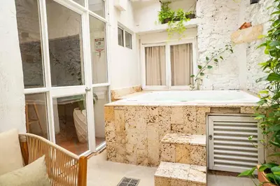 a bathroom with a bath tub in a building at Casa Quero 914, 3br Old city wifi jacuzzi in Cartagena de Indias