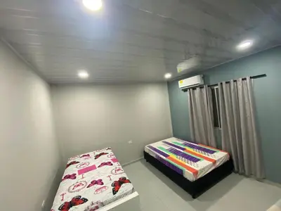 a bedroom with a bed in a room with a ceiling at APARTAMENTOS AMOBLADOS in Santa Marta