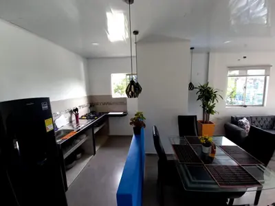 a kitchen and dining room with a dining table at APARTAMENTOS AMOBLADOS in Santa Marta