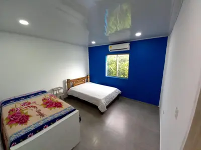 a small bedroom with a bed and a window at APARTAMENTOS AMOBLADOS in Santa Marta
