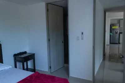 a bedroom with a door leading to a kitchen at Apartasol Amoblado Primer Piso Coveñas in Coveñas