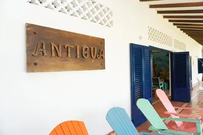 a room with chairs and a sign that reads antigua at Casa Antigua in San Silvestre