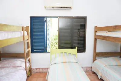 a room with two bunk beds and a window at Casa Antigua in San Silvestre