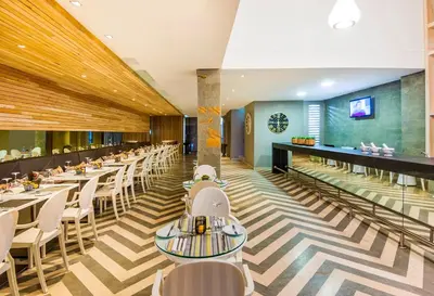 a dining room with tables and white chairs at Oz Hotel Cartagena in Cartagena de Indias