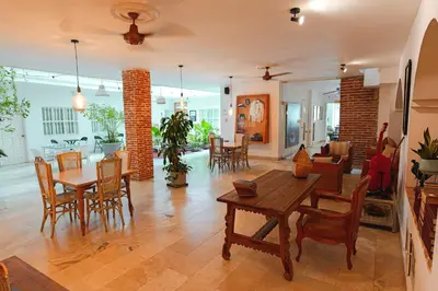 a living room with a table and chairs at Hotel Kartaxa in Cartagena de Indias