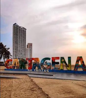 a sign on the beach in front of a city at Cabrero Beach 1111 in Cartagena de Indias