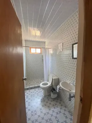 a bathroom with a toilet and a sink at CABAÑA ACUARIO in El Porvenir