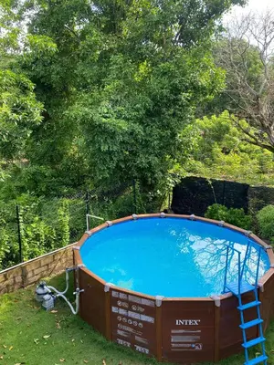 a large swimming pool with a ladder next to it at CABAÑA ACUARIO in El Porvenir