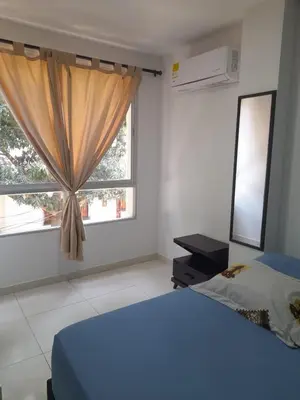a bedroom with a blue bed and a window at Apartaestudio Cartagena 2P in Cartagena de Indias