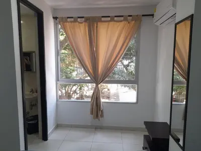 a window with a curtain in a room at Apartaestudio Cartagena 2P in Cartagena de Indias