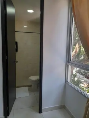 a bathroom with a toilet and a window at Apartaestudio Cartagena 2P in Cartagena de Indias