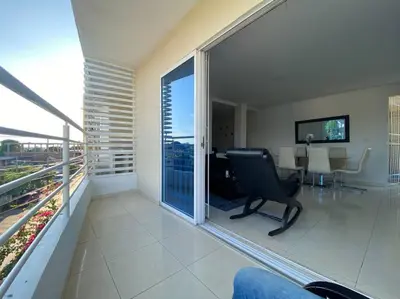 a room with a balcony with a chair and a table at Lindo Apartamento vacacional in Cartagena de Indias
