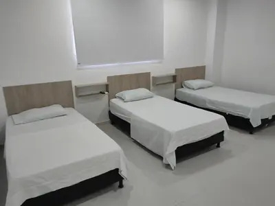a hospital room with three beds and a window at HOTEL MAR DEL CARIBE in Soledad