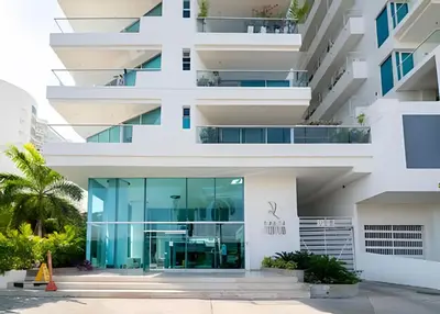 an external view of a building with a glass facade at 1 Dormitorio con salida directa playa de Morros in Cartagena de Indias