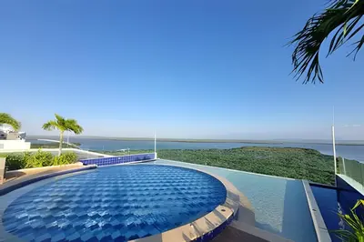 a swimming pool in a house with a view of the ocean at 1 Dormitorio con salida directa playa de Morros in Cartagena de Indias