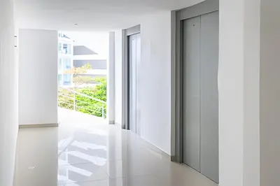 a hallway with white walls and a glass door at 1 Dormitorio con salida directa playa de Morros in Cartagena de Indias