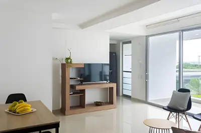 a kitchen with white walls and a table and chairs at 1 Dormitorio con salida directa playa de Morros in Cartagena de Indias