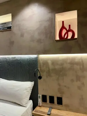 a bedroom with a bed and a table with a lamp at Casa Ebano 967 in Cartagena de Indias
