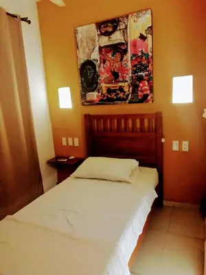 a bedroom with a bed and a painting on the wall at Casa Ebano 967 in Cartagena de Indias