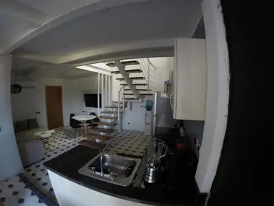 a kitchen with a sink and a staircase in a room at Casa Ebano 967 in Cartagena de Indias