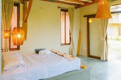 a bedroom with a white bed with two towels on it at Casa Mambo Salinas in Santa Veronica
