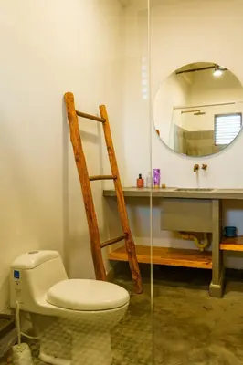 a bathroom with a toilet and a mirror at Casa Mambo Salinas in Santa Veronica