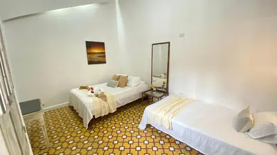 a hotel room with two beds and a mirror at Casa Ego in Cartagena de Indias