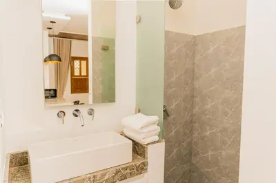 a bathroom with a sink and a mirror at Del Mar Guest House in Cartagena de Indias