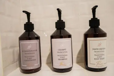 three bottles of shampoo sitting on a bathroom counter at Del Mar Guest House in Cartagena de Indias