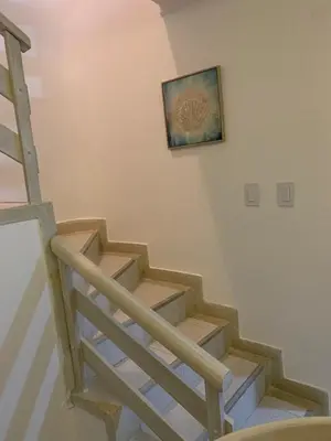 a stairway with a picture hanging on the wall at Cabaña 8 Arrecifes in Coveñas