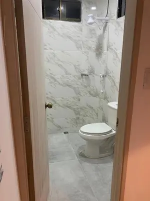 a white bathroom with a toilet and a shower at Cabaña 8 Arrecifes in Coveñas